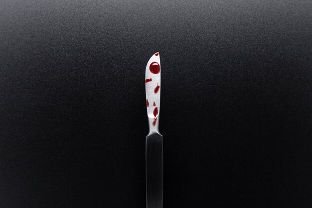 Top view of bloody medical scalpel