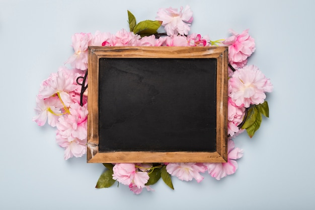 Top view blossom flowers around frame