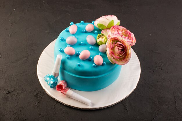 A top view blue birthday cake with flower on top on the grey desk celebration party birthday color cake