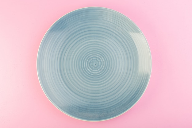 A top view blue empty plate glass made plate for meal on pink