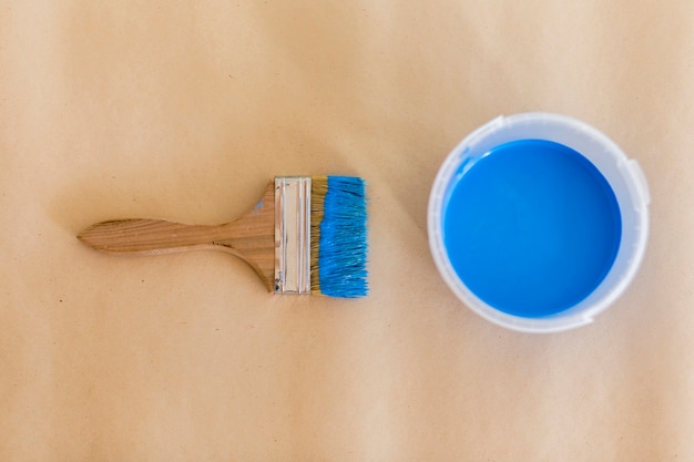 Free photo top view of blue paint and paint brush