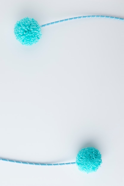 Top view blue pom poms with copy space