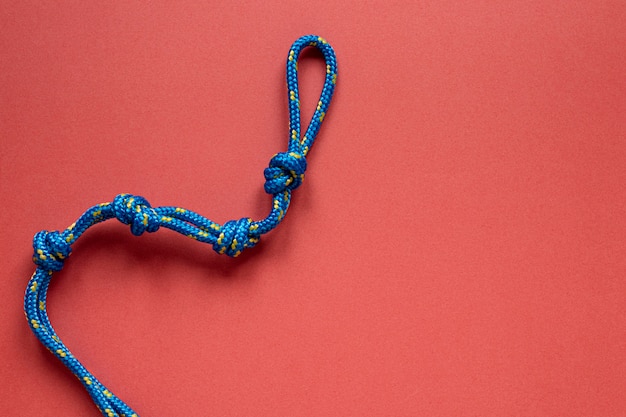 Free photo top view blue rope with knot copy space