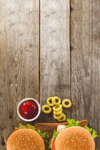 Free photo top view of boards with burgers and onion rings