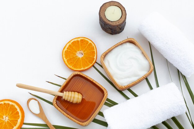 Top view of body butter cream and orange slices