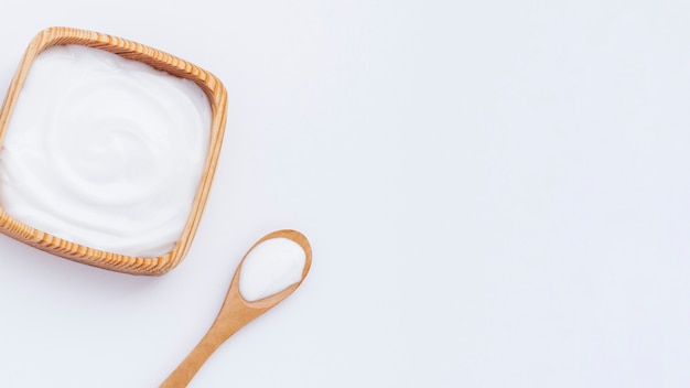 Top view of body butter on plain background with copy space