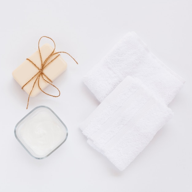 Top view of body butter and soap on plain background