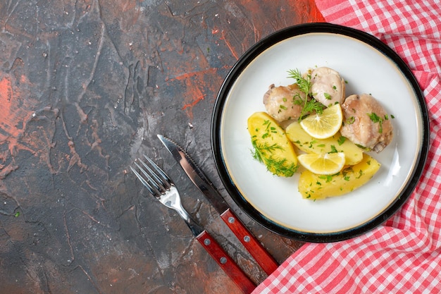 Top view boiled chicken with cooked potatoes greens and lemon on dark background cuisine dish color food meat calorie dinner sauce