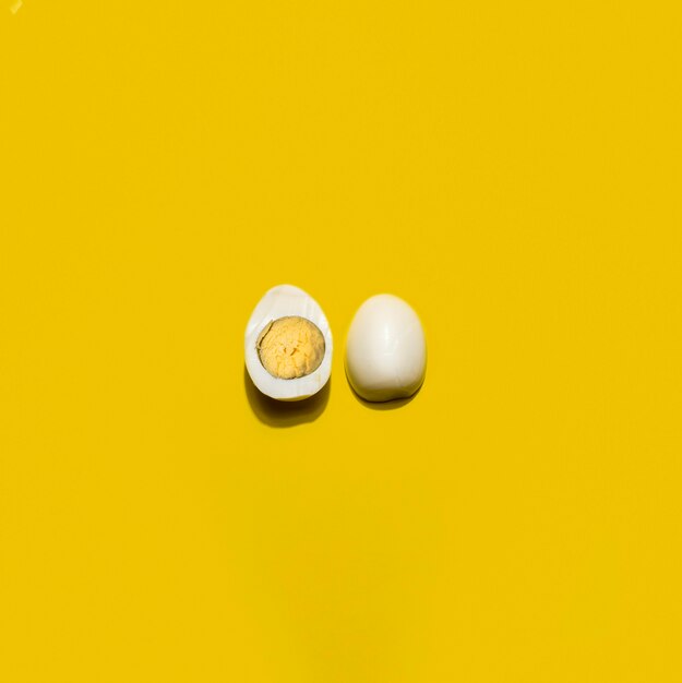 Top view boiled egg on yellow background