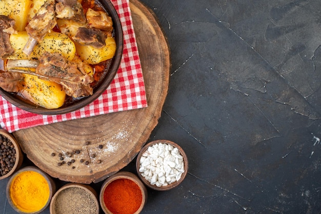 Top view boiled meat with cooked potatoes and seasonings on dark background dish sauce cuisine hot dinner kitchen cooking