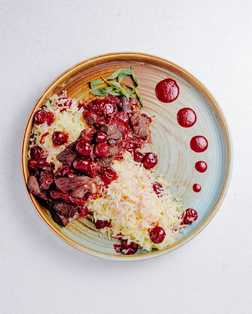 Free photo top view of boiled rice meat and cherries