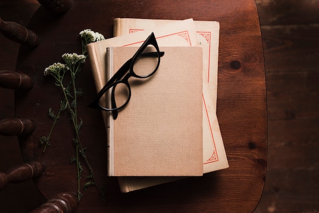 biography book layout Free photo top view of book, flowers and glasses