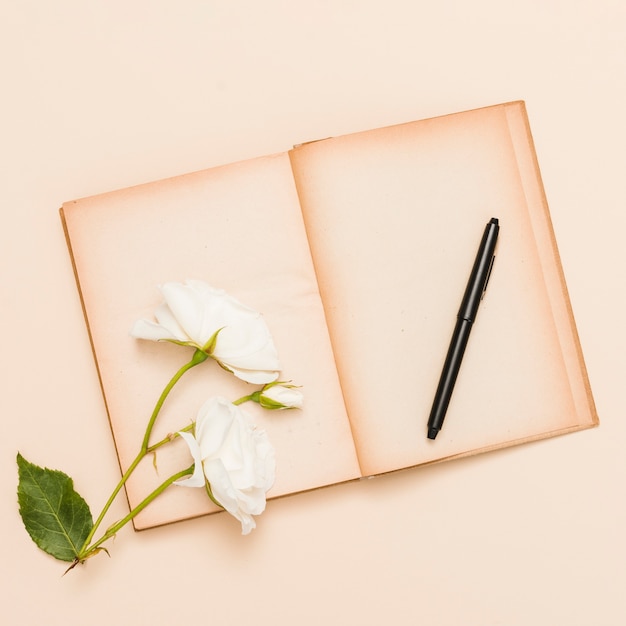 Free photo top view of book and flowers