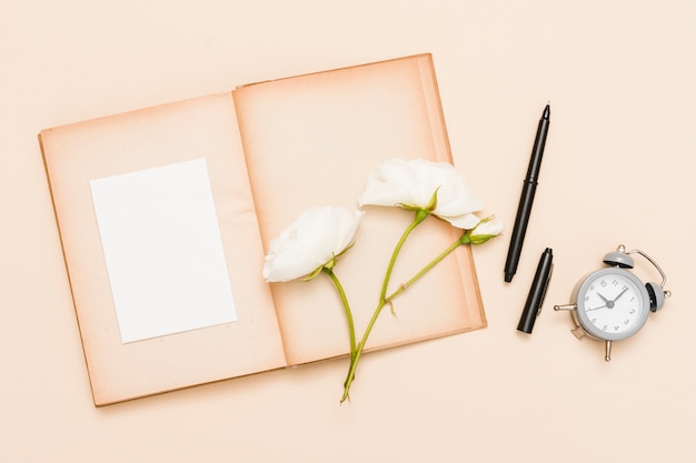 Free photo top view of book and flowers