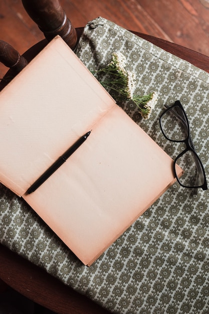 Top view of book and glasses