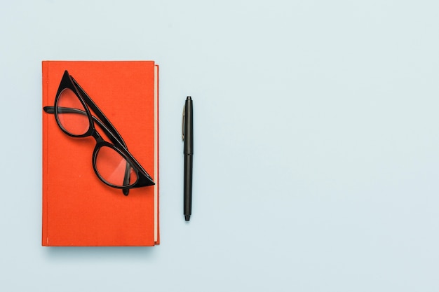 Top view of book and glasses