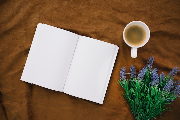 Top view book mockup with coffee and flowers