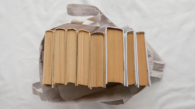 Top view books stack in bag