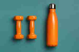 Free photo top view bottle and dumbbells