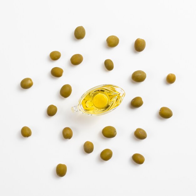 Top view of bottle with oil and green olives