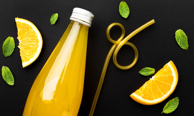 Top view of bottle with soft drink and orange slices