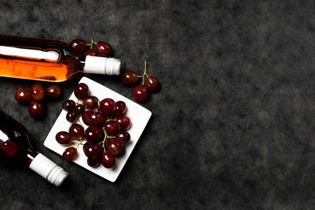 Top view bottles of wine with grapes