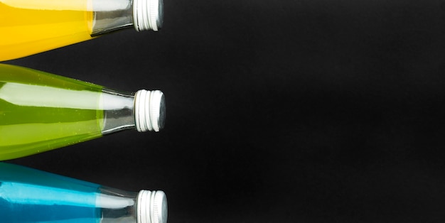 Top view of bottles with soft drinks and copy space