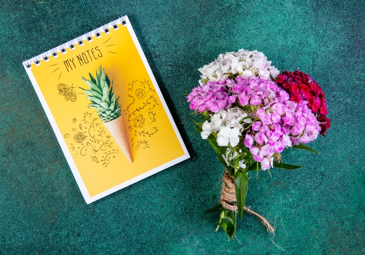Free Photo top view bouquet of colorful flowers with yellow notes on green