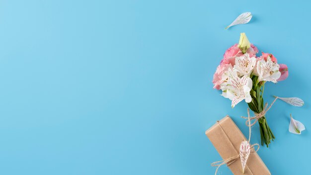 Top view of bouquet of flowers with gift box and copy space