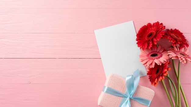 Top view of bouquet of flowers with gift box and copy space