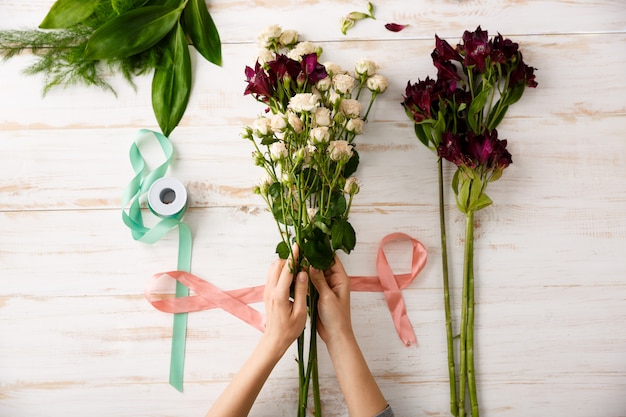 Top view bouquet of flowers on wooden table