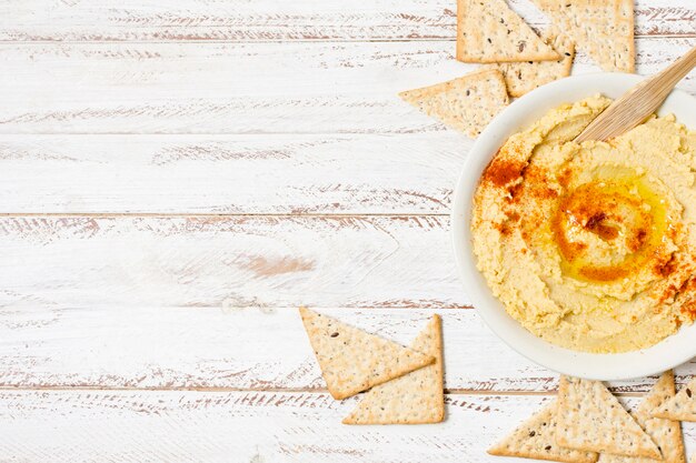 Top view of bowl of hummus with copy space