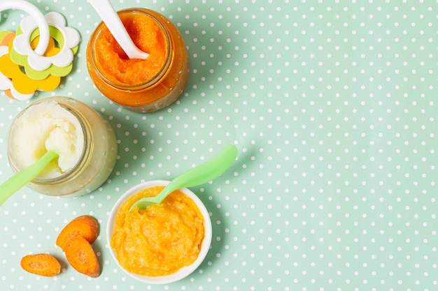 Top view bowl and jars with baby food