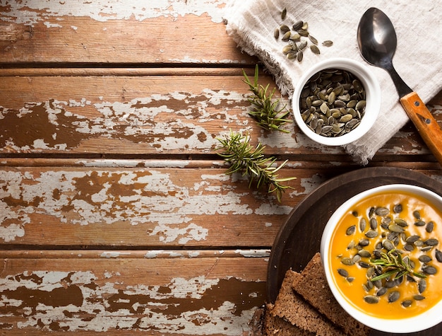 Top view of bowl with autumn squash soup and copy space