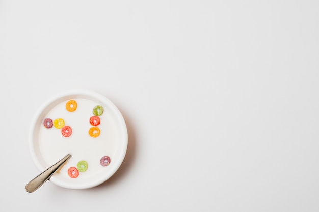 Top view bowl with cereals on white background