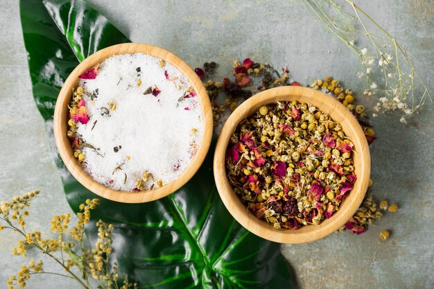 Top view bowl with dry chamomile and mineral salt