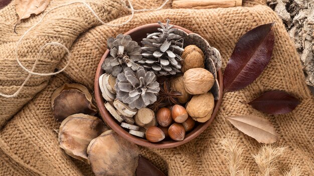 Top view of bowl with pine cones and nuts on burlap