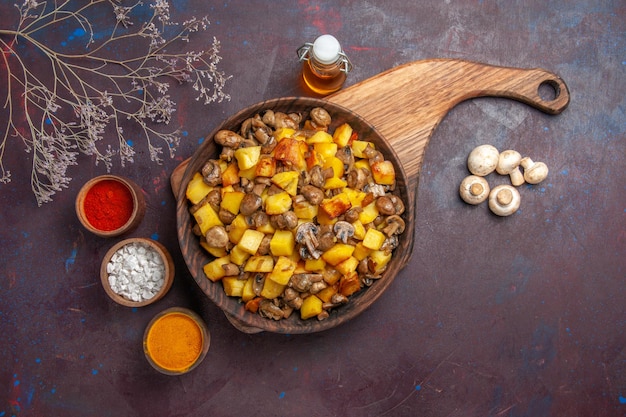 Top view bowl with potatoes and mushrooms bowl with potatoes and mushrooms oil in bottle colorful spices and white mushrooms