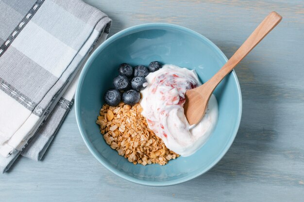 Top view bowl with yogurt and oats on the table