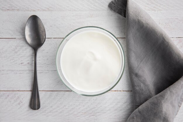 Top view bowl with yogurt and spoon