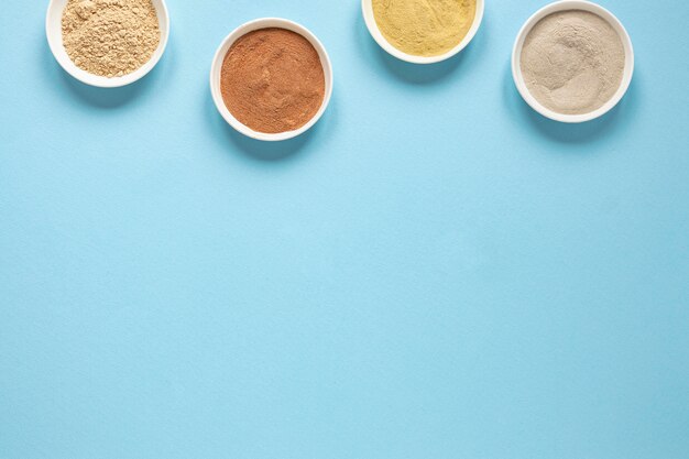 Top view bowls filled with coloured sand copy space