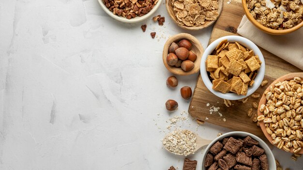 Top view of bowls with assortment of breakfast cereals and copy space