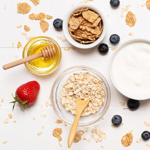 Top view bowls with cereals and honey