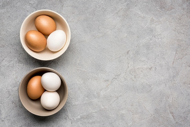 Top view bowls with chicken eggs