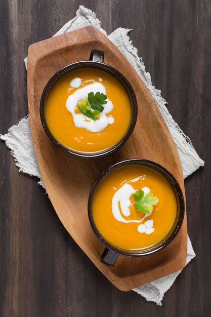 Top view bowls with pumpkin soup