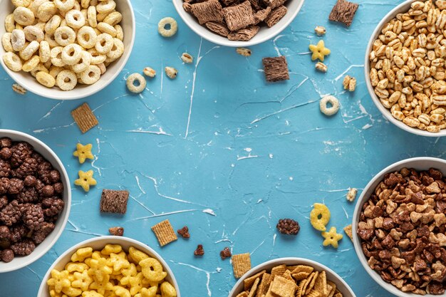 Top view of bowls with selection of breakfast cereals