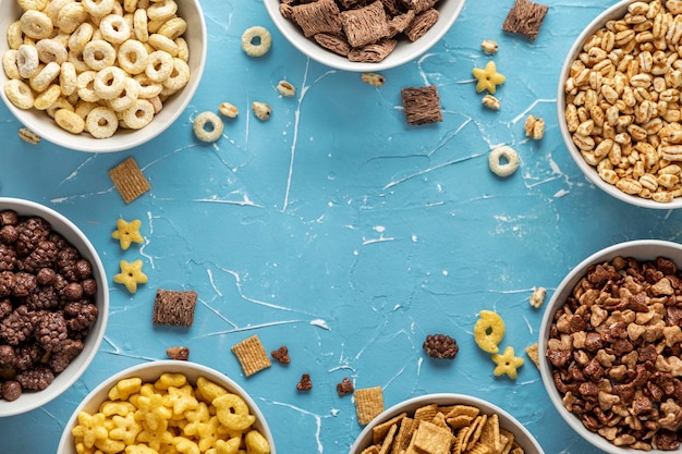 Top view of bowls with selection of breakfast cereals