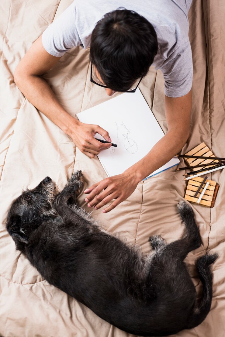 Free Photo top view boy drawing with charcoal with dog