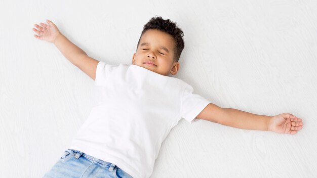 Top view of boy posing with arms out