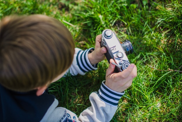 Top view of boy with photo camera